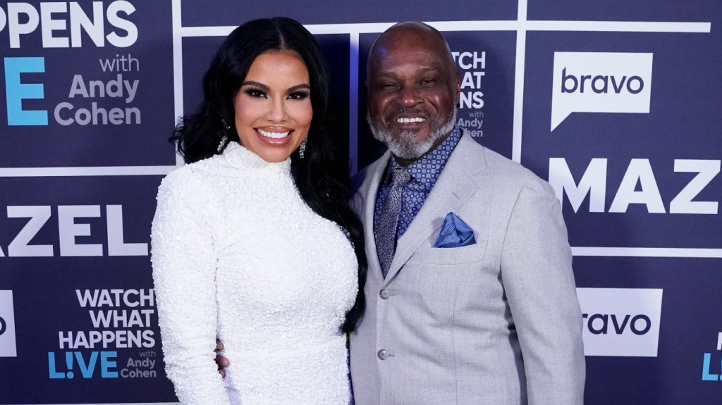 Mia Thornton in a white dress standing next to Gordon Thorton in a grey suit.