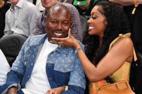 Simon Guobadia and Porsha Williams sitting courtside at a basketball game, they're both smiling and she has her hand on his face