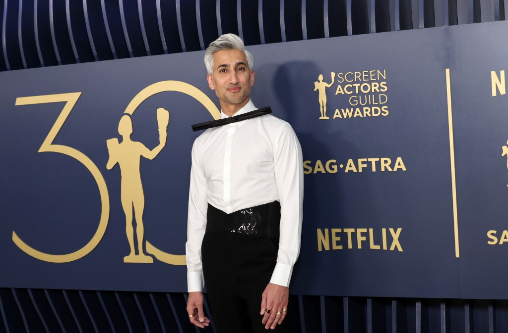 Tan France in a white blouse and black pants posing at the 30th annual SAG awards