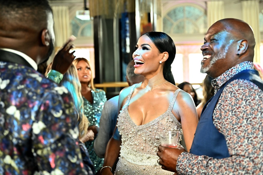 Mia Thornton and Gordon Thornton smiling and talking to their costars during an episode of The Real Housewives of Potomac Season 7