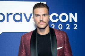 Luke Gulbranson in a red suit posing at BravoCon 2022