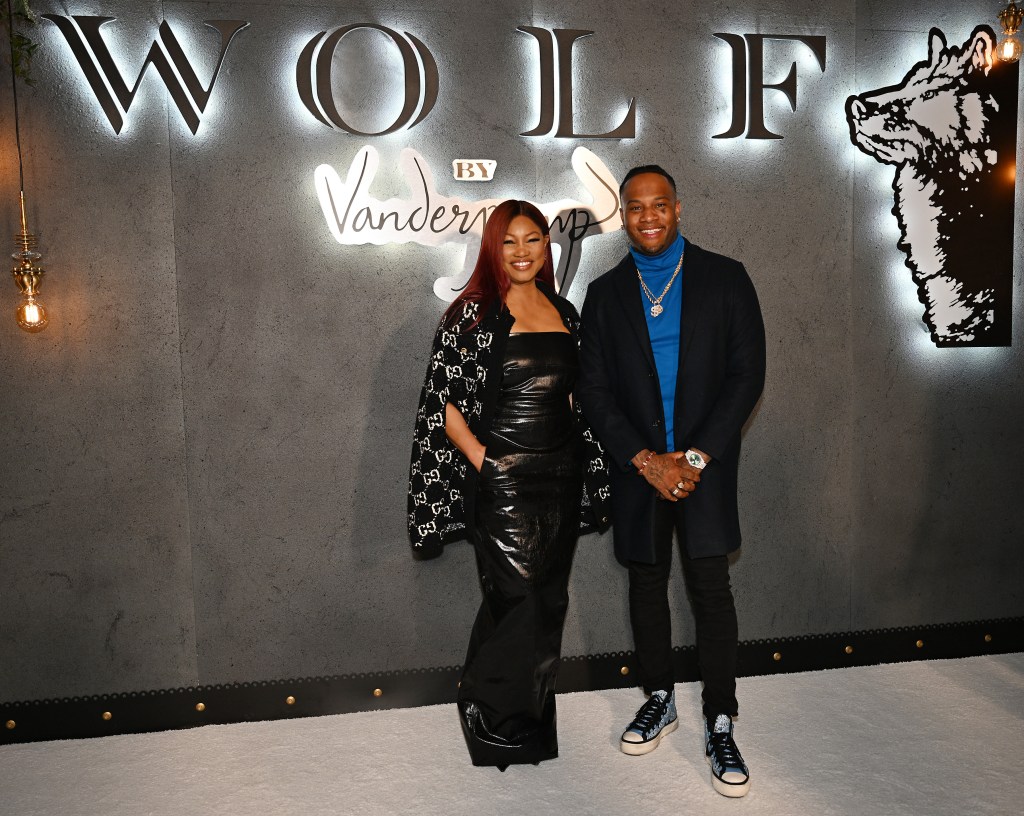 Garcelle Beauvais and Oliver Saunders standing together at Wolf by Vanderpump