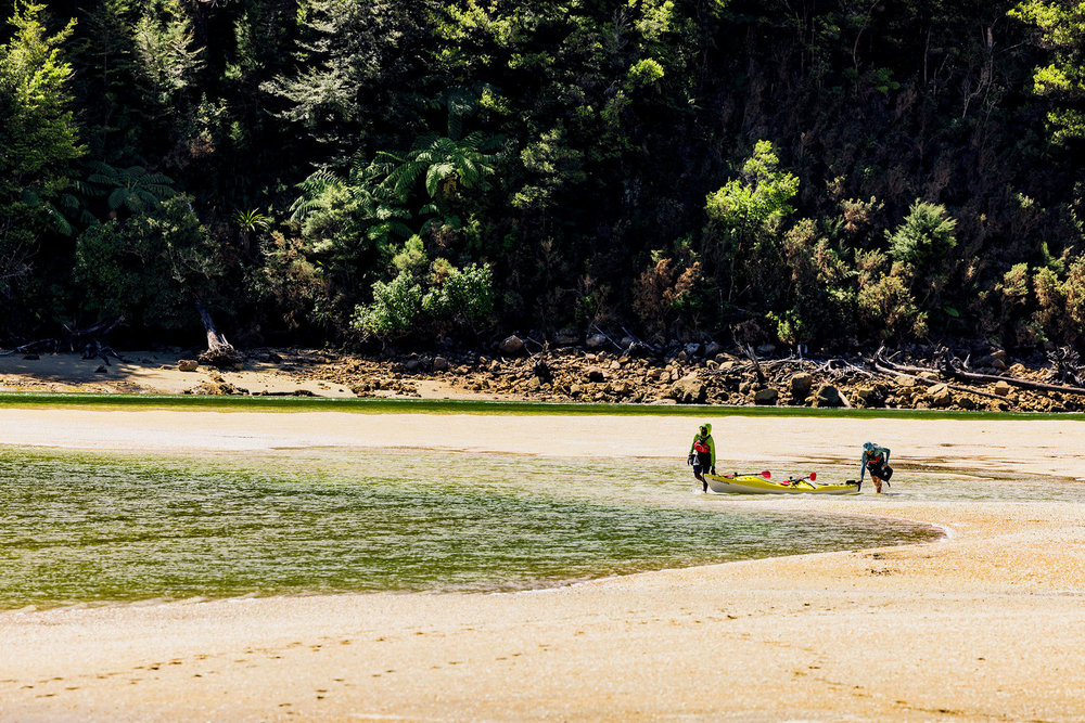 Oliver and Corry walking across the beach on Race to Survive: New Zealand