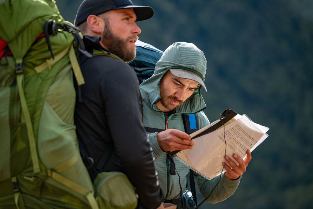 Tyrie and Ethan looking at a map on Race to Survive: New Zealand