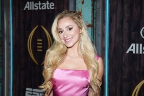 Renee Poche at an event smiling and wearing a pink dress