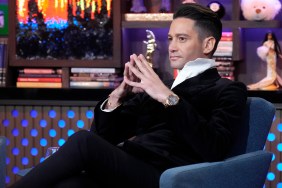 Josh Flagg in a black suit gesturing with his hands on Watch What Happens Live