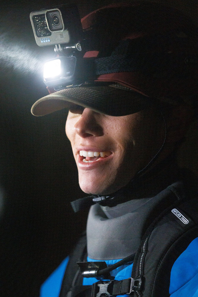 Bronsen Iverson wearing a helmet light in a cave on Race to Survive: New Zealand