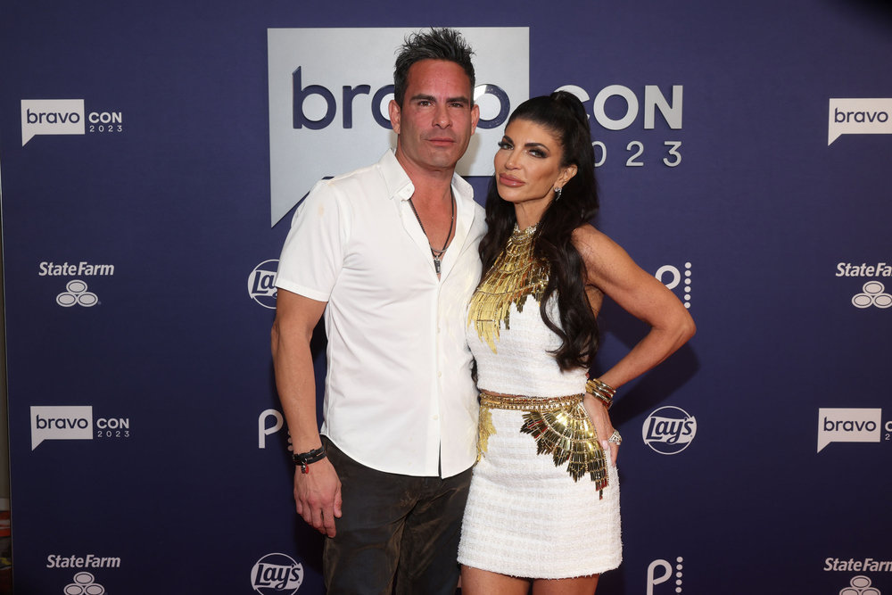 Luis Ruelas and Teresa Giudice giving duck face at BravoCon 2023. 