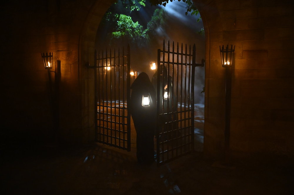 Two Traitors walking through the castle grounds in Season 3 of The Traitors