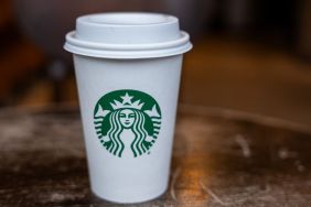 In this photo illustration, a Starbucks coffee cup sits on a table at a store in Manhattan on January 30, 2024 in New York City. The global coffee chain officially introduced its extra virgin olive oil-infused drinks on Tuesday. Named Oleato, the drinks debuted in Italy in February 2023 and arrive in stores on the same day Starbucks will report fourth-quarter earnings.