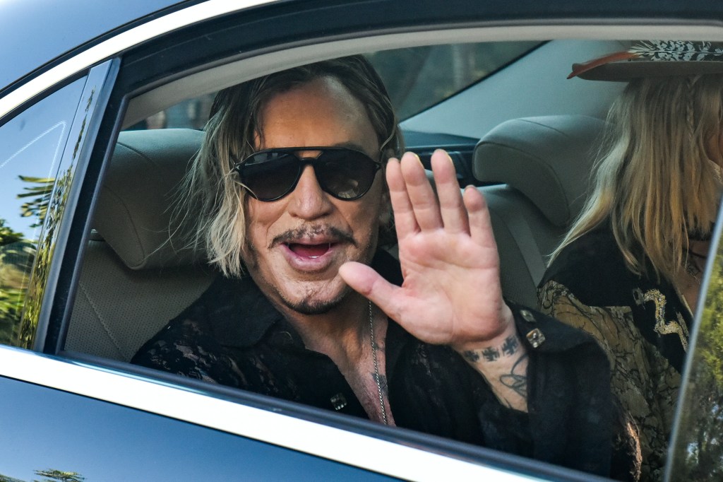 Mickey Rourke waving out of a car window
