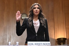 Kristi Noem raising her hand at a Senate hearing