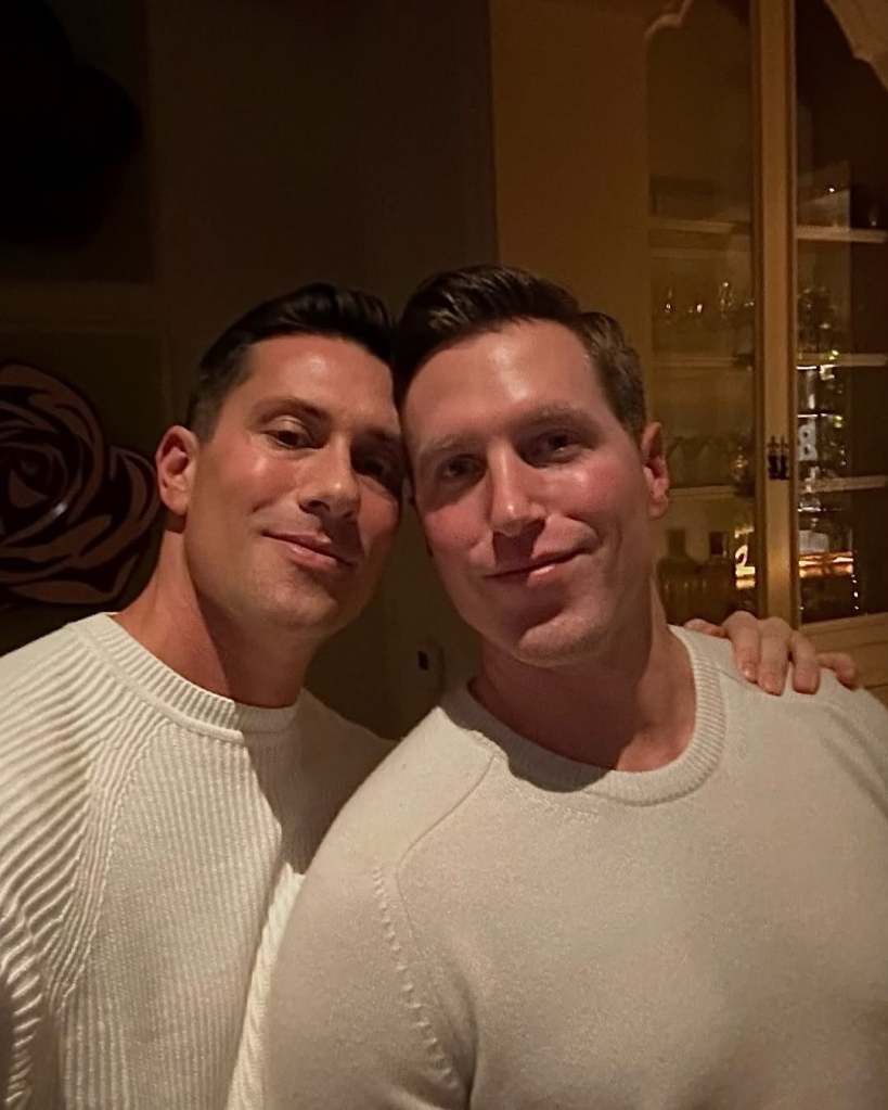 Gage Edward and Scott Anderson posing together in white sweaters