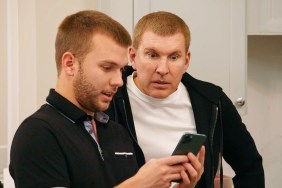 In a screen grab from Chrisley Knows Best, Chase Chrisley is showing something to Todd Chrisley on his phone