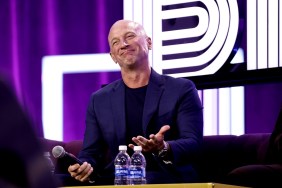 Captain Kerry smirking and raising his hands while on stage at BravoCon 2023