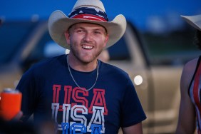 Cole McBee showing his teeth and wearing a USA t-shirt and matching cowboy hat