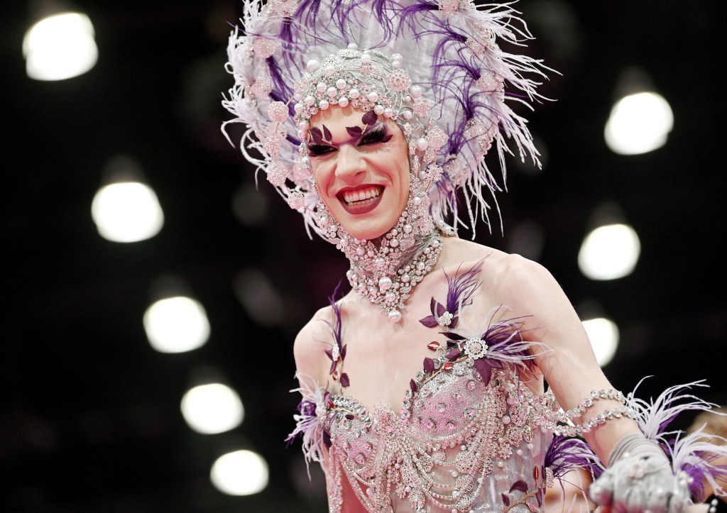 Utica Queen in a purple and silver head dress at Drag Con 2024