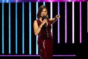 Vanessa Lachey in a red dress at Netflix's Tudum Live pointing at the camera