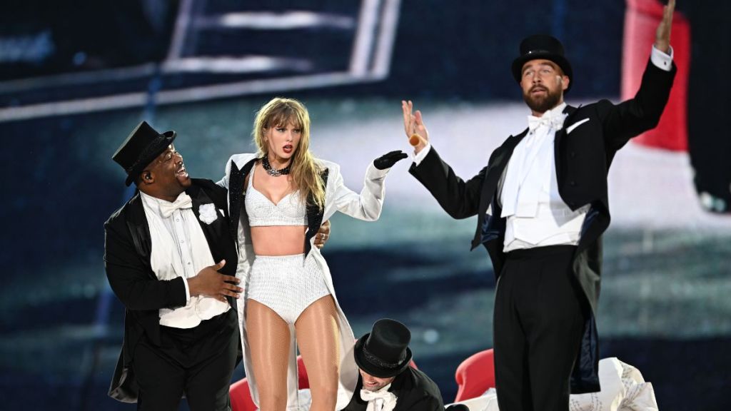 Taylor Swift is joined on stage by Travis Kelce (R), during "Taylor Swift | The Eras Tour" at Wembley Stadium on June 23, 2024 in London, England