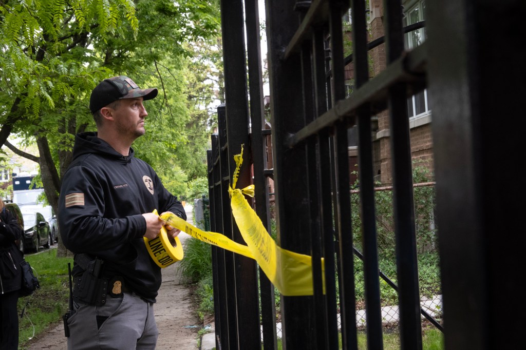 A police officer taping off a crime scene